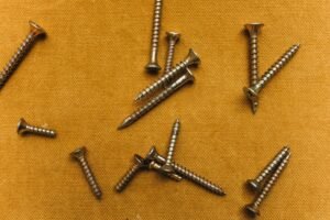 screws on yellow surface