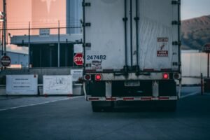 white freight truck close up photography