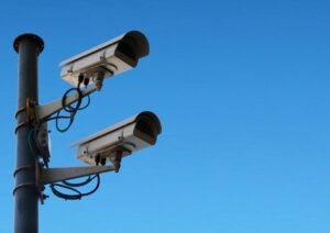 surveillance cameras against blue sky