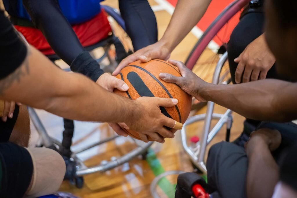 group of men on wheelchair holding a basketball together