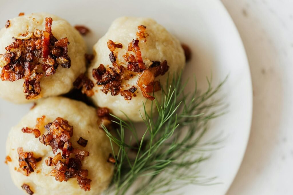 potato dumplings with toasted bacon and dill sprig
