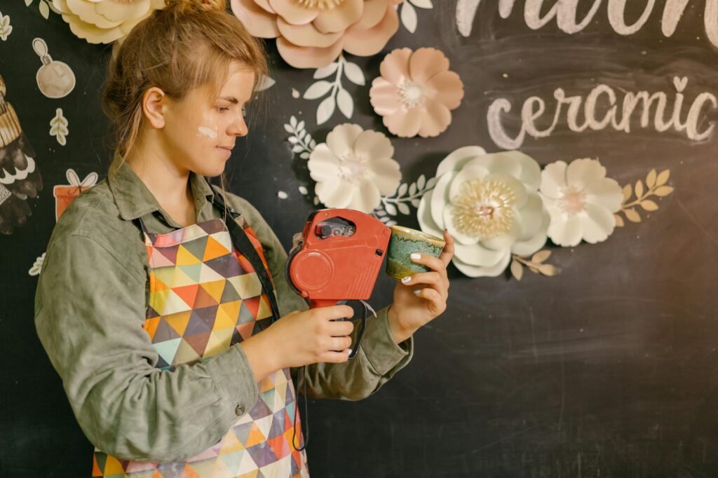 woman in apron labeling handmade cup