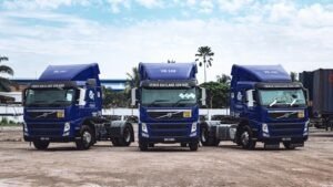 a couple of blue trucks parked next to each other