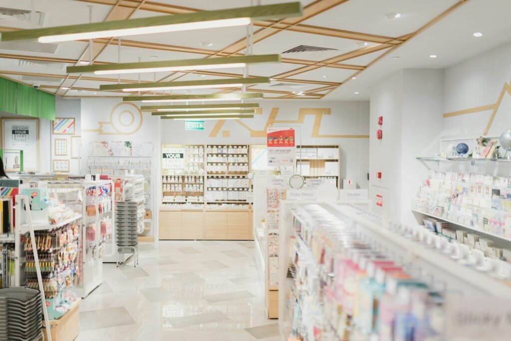 A bright stationery store interior with shelves of greeting cards and office supplies